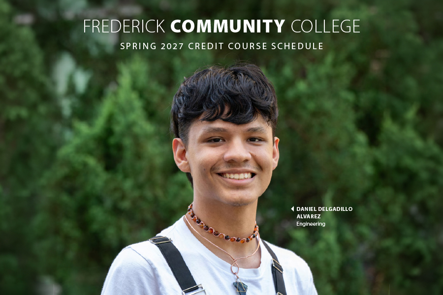 frederick community college spring schedule cover featuring a dark haired mail student wearing a white shirt and orange and black necklace.